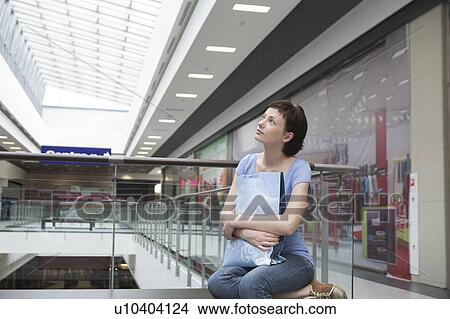 Picture - Young woman sits in new Voronezh shopping centre. Fotosearch