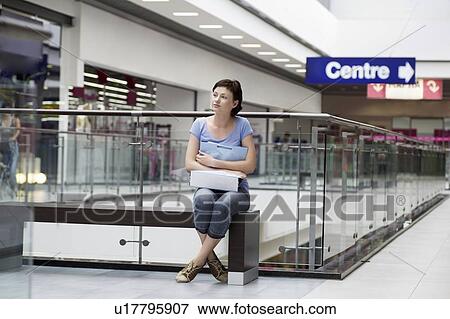 Young woman sits in new Voronezh shopping centre View Large Photo Image Stock Photo - Young woman sits in new Voronezh shopping centre. Fotosearch