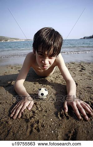 Boy with small soccer ball on beach View Large Photo Image Stock Image - Boy with small soccer ball on beach. Fotosearch