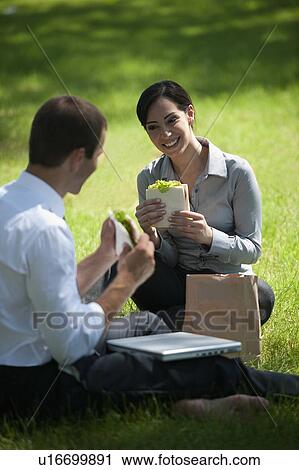 Business people eating lunch on grass View Large Photo Image Stock Image - Business people eating lunch on grass. Fotosearch