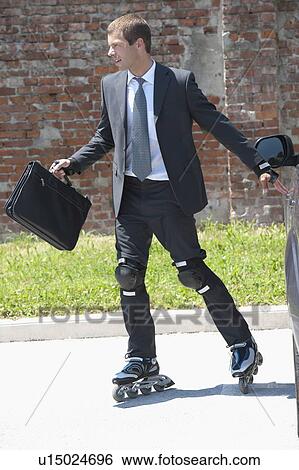 Businessman in suit inline skating View Large Photo Image Stock Photograph - Businessman in suit inline skating. Fotosearch