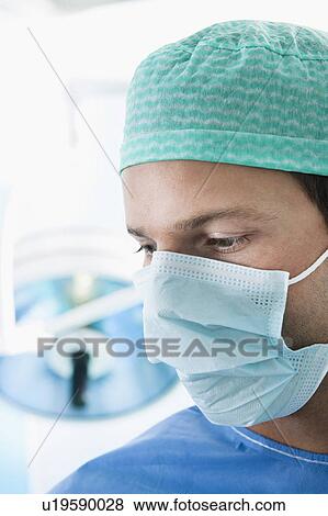 Close up of surgeon in operating room View Large Photo Image Stock Photo - Close up of surgeon in operating room. Fotosearch