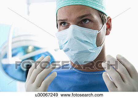 Close up of surgeon in operating room View Large Photo Image Stock Photo - Close up of surgeon in operating room. Fotosearch