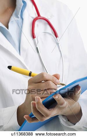 Stock Photo - Closeup of doctor writing on pad. Fotosearch