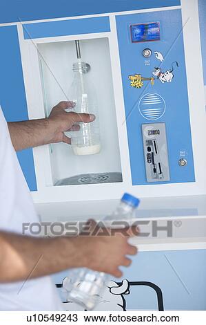 Closeup of man's hands filling milk bottle at cooler View Large Photo Image Stock Image - Closeup of man's hands filling milk bottle at cooler. Fotosearch