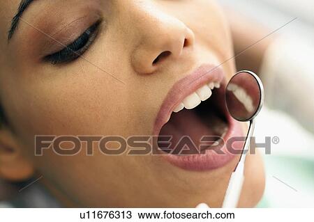 Closeup of patient's face at dentist View Large Photo Image Stock Image - Closeup of patient's face at dentist. Fotosearch