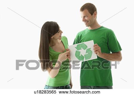 Stock Photography - Couple holding recycling symbol drawing. Fotosearch
