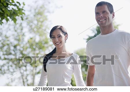 Couple in white shirts outdoor View Large Photo Image Stock Image - Couple in white shirts outdoor. Fotosearch