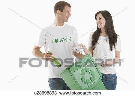 Couple throwing glass and plastic bottles in the recycling bin View Large Photo Image Stock Image - Couple throwing glass and plastic bottles in the recycling bin. Fotosearch
