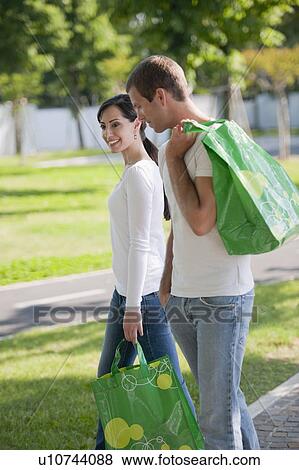 Stock Photo - Couple with reusable shopping bags. Fotosearch