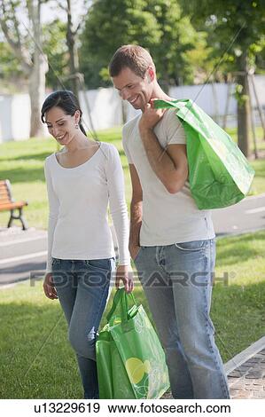 Stock Photo - Couple with reusable shopping bags. Fotosearch