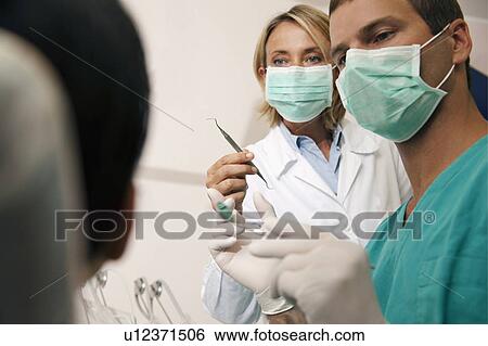Dental professionals with patient View Large Photo Image Stock Photograph - Dental professionals with patient. Fotosearch