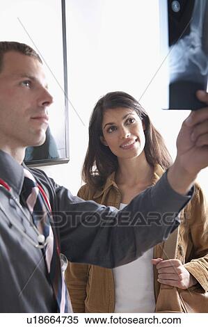 Stock Photography - Doctor and patient looking at xray . Fotosearch