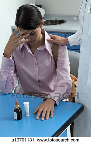 Stock Image - Doctor consoling patient. Fotosearch