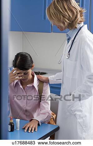 Stock Image - Doctor consoling patient. Fotosearch