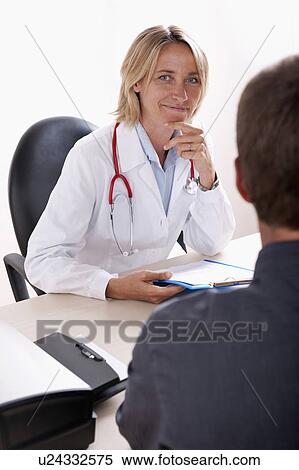 Doctor discussing medical results with patient View Large Photo Image Stock Photography - Doctor discussing medical results with patient. Fotosearch