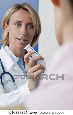 Stock Photography - Doctor giving patient medicine. Fotosearch