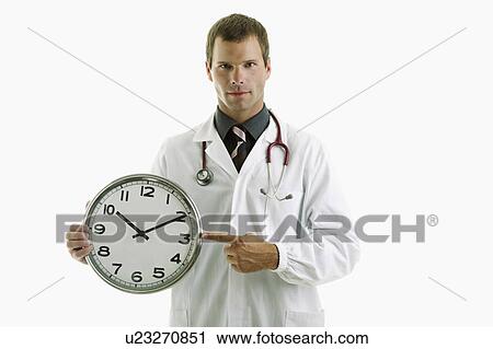 Doctor holding clock showing time View Large Photo Image Stock Image - Doctor holding clock showing time. Fotosearch