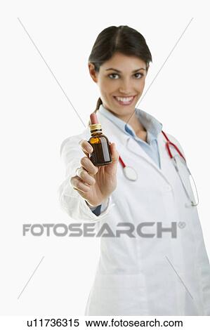 Doctor holding medicine bottle View Large Photo Image Stock Photography - Doctor holding medicine bottle. Fotosearch