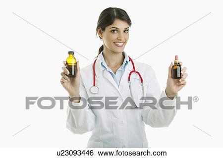Stock Photograph - Doctor holding medicine bottles. Fotosearch