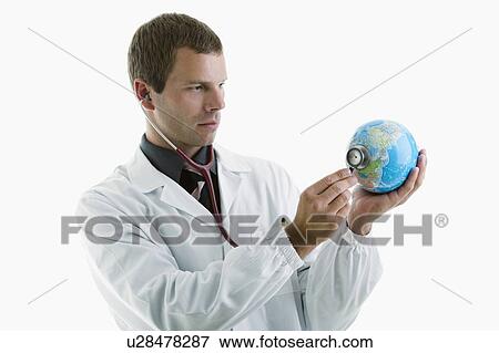 Doctor holding stethoscope to globe View Large Photo Image Stock Photo - Doctor holding stethoscope to globe . Fotosearch