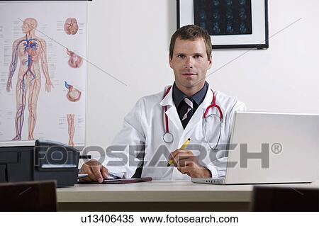 Doctor in his office with circulatory system chart and laptop View Large Photo Image Stock Photography - Doctor in his office with circulatory system chart and laptop. Fotosearch
