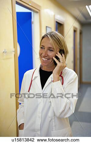 Doctor making telephone call in medical center View Large Photo Image Stock Image - Doctor making telephone call in medical center. Fotosearch