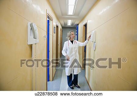 Stock Photo - Doctor making telephone call in medical center. Fotosearch