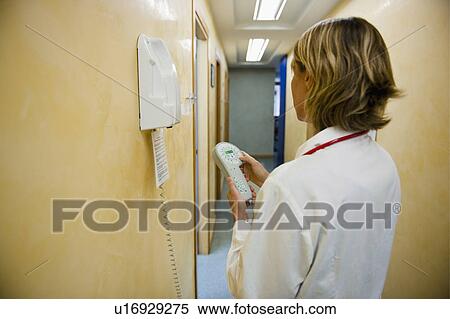 Doctor making telephone call in medical center View Large Photo Image Stock Photography - Doctor making telephone call in medical center. Fotosearch