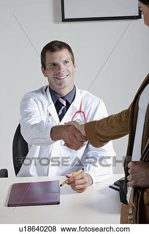 Stock Photo - Doctor shaking hands with patient. Fotosearch