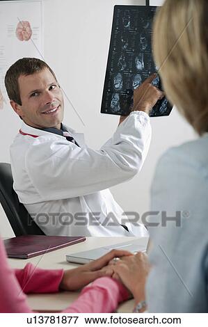 Doctor showing MRI to patient View Large Photo Image Stock Photo - Doctor showing MRI to patient . Fotosearch