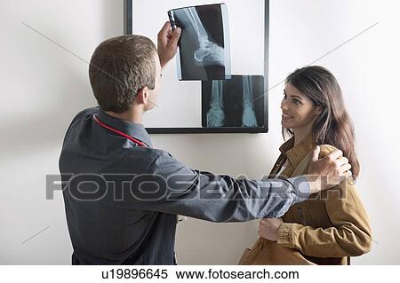 Doctor showing Xray to patient View Large Photo Image Stock Photography - Doctor showing Xray to patient. Fotosearch