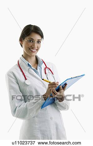 Stock Photo - Doctor wearing stethoscope and writing on chart. Fotosearch