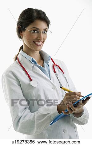 Stock Photograph - Doctor wearing stethoscope and writing on chart. Fotosearch