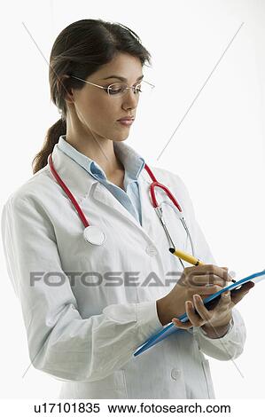 Doctor wearing stethoscope and writing on chart View Large Photo Image Stock Photography - Doctor wearing stethoscope and writing on chart. Fotosearch
