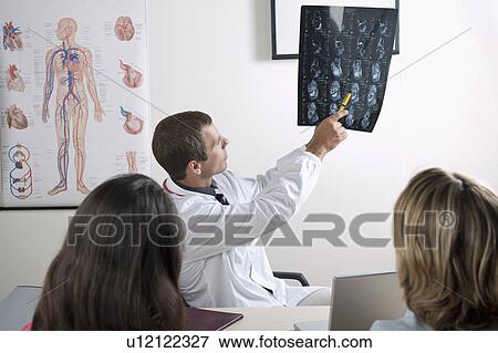Doctor with MRI of ankle and patients View Large Photo Image Stock Photo - Doctor with MRI of ankle and patients. Fotosearch
