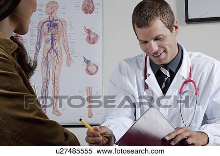 Stock Photography - Doctor with patient in office. Fotosearch