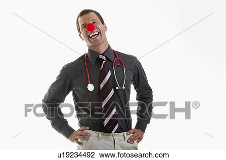 Stock Image - Doctor with stethoscope and clown's nose. Fotosearch