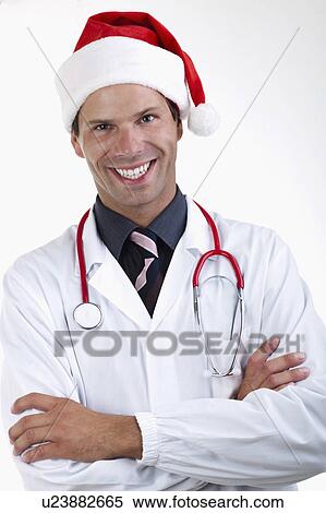 Stock Photography - Doctor with stethoscope and Santa's hat. Fotosearch
