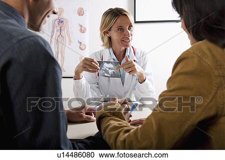 Doctor with ultrasound and couple View Large Photo Image Stock Image - Doctor with ultrasound and couple. Fotosearch