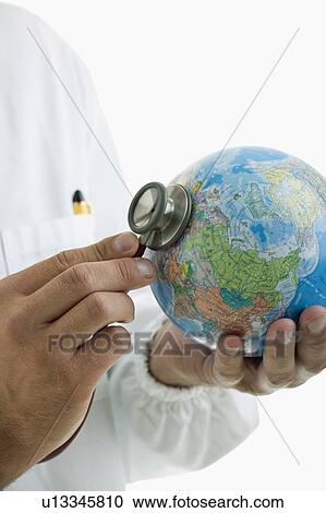 Doctor's hands holding stethoscope to globe View Large Photo Image Stock Image - Doctor's hands holding stethoscope to globe . Fotosearch