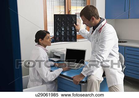 Stock Photography - Doctors looking at a MRI of ankle. Fotosearch