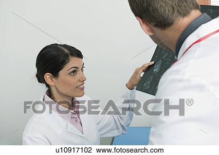 Stock Image - Doctors looking at an MRI. Fotosearch