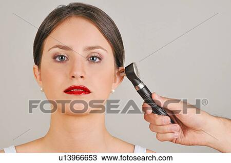 Female young adult and doctor's hand holding otoscope View Large Photo Image Stock Image - Female young adult and doctor's hand holding otoscope. Fotosearch