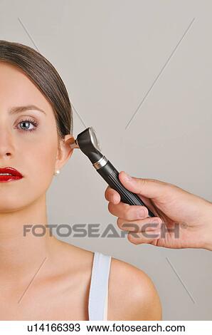 Female young adult and doctor's hand holding otoscope View Large Photo Image Stock Image - Female young adult and doctor's hand holding otoscope. Fotosearch
