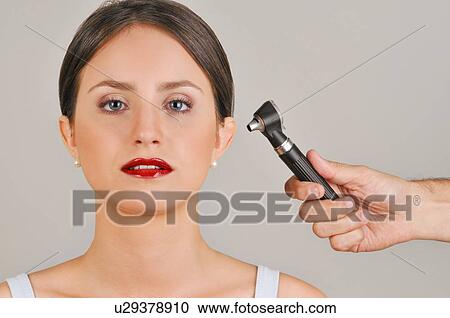 Female young adult and doctor's hand holding otoscope View Large Photo Image Stock Image - Female young adult and doctor's hand holding otoscope. Fotosearch