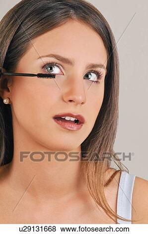 Female young adult applying mascara View Large Photo Image Stock Photo - Female young adult applying mascara. Fotosearch