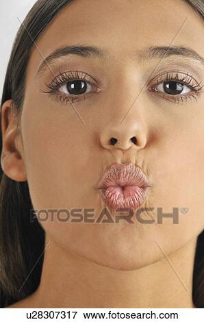 Stock Photo - Female young adult blowing a kiss. Fotosearch