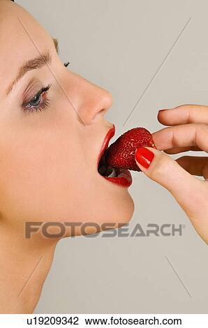 Female young adult eating a strawberry View Large Photo Image Stock Image - Female young adult eating a strawberry. Fotosearch