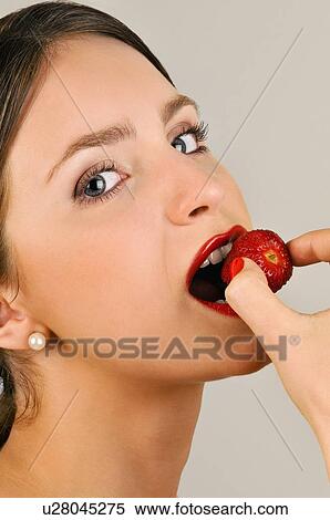 Female young adult eating a strawberry View Large Photo Image Stock Photography - Female young adult eating a strawberry. Fotosearch